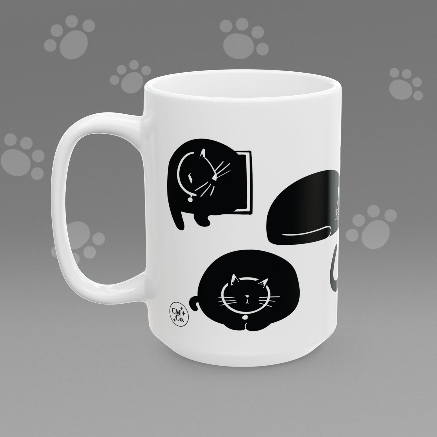 Coffee mug with fat black cat illustrations on a gray background