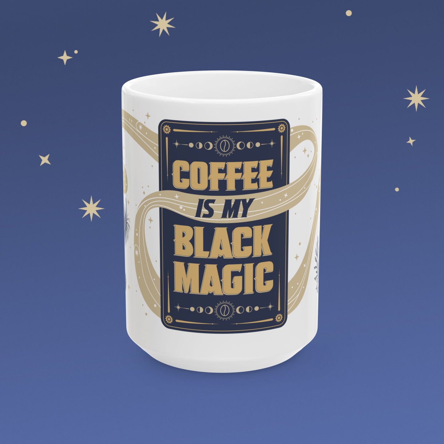 White mug with 'Coffee is my black magic' text on a blue background with stars
