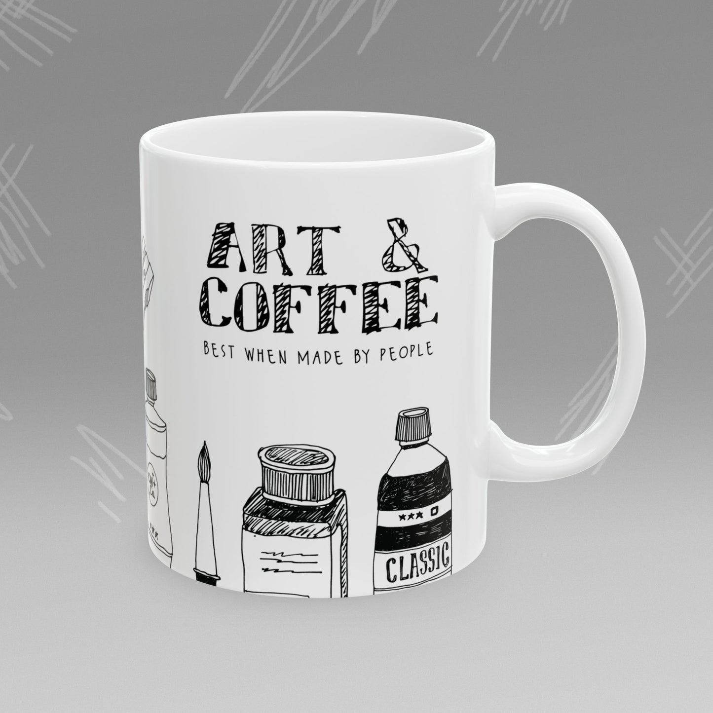 White mug with black text and illustrations of art supplies