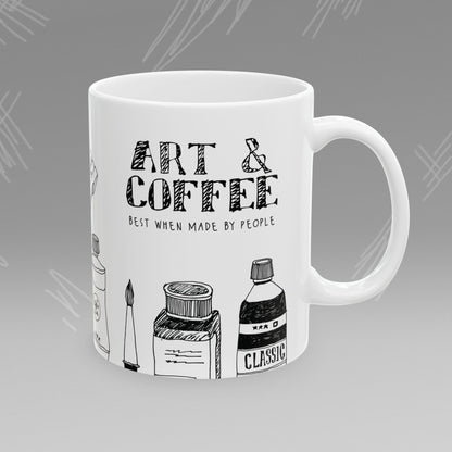 White mug with black text and illustrations of art supplies