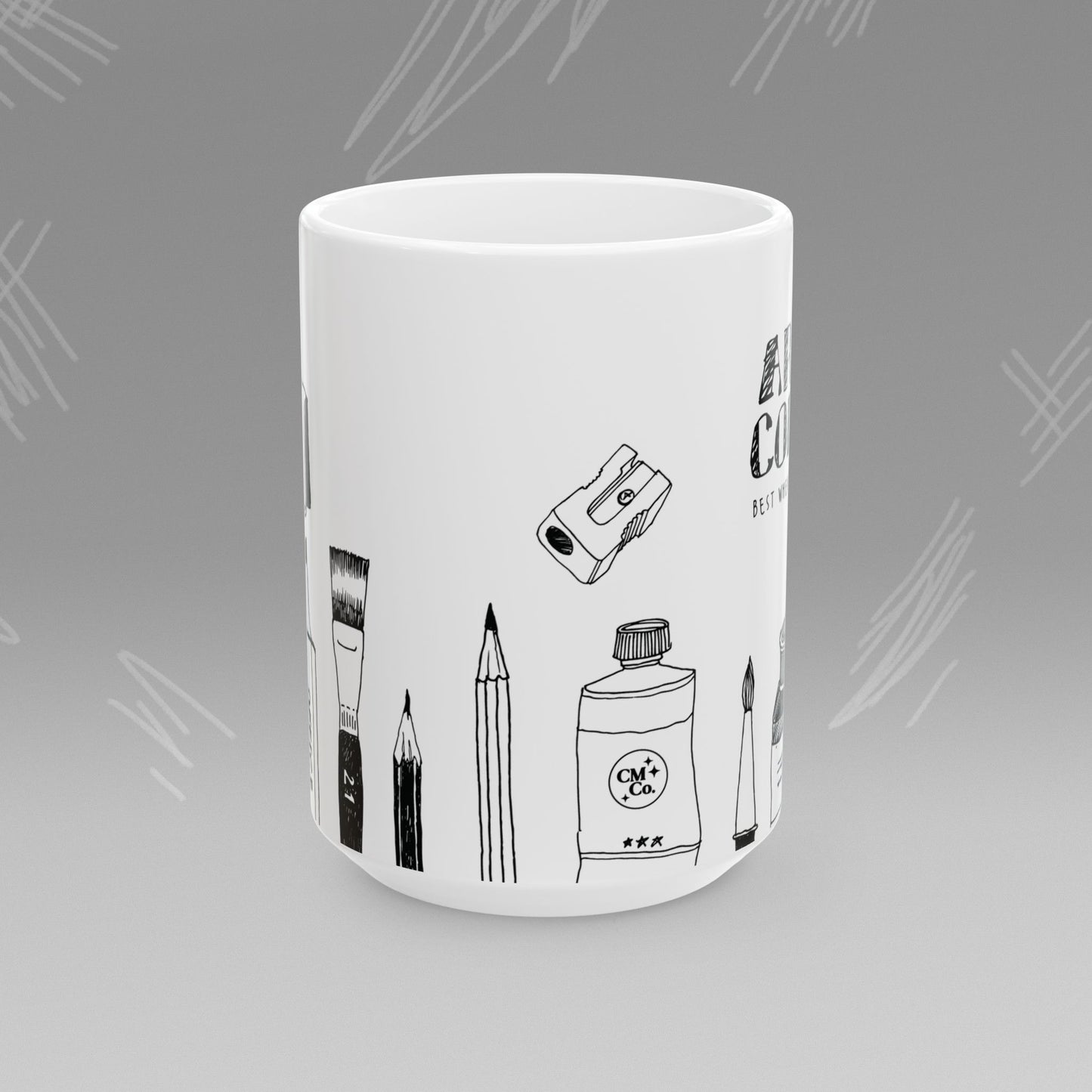 White mug with black text and illustrations of art supplies