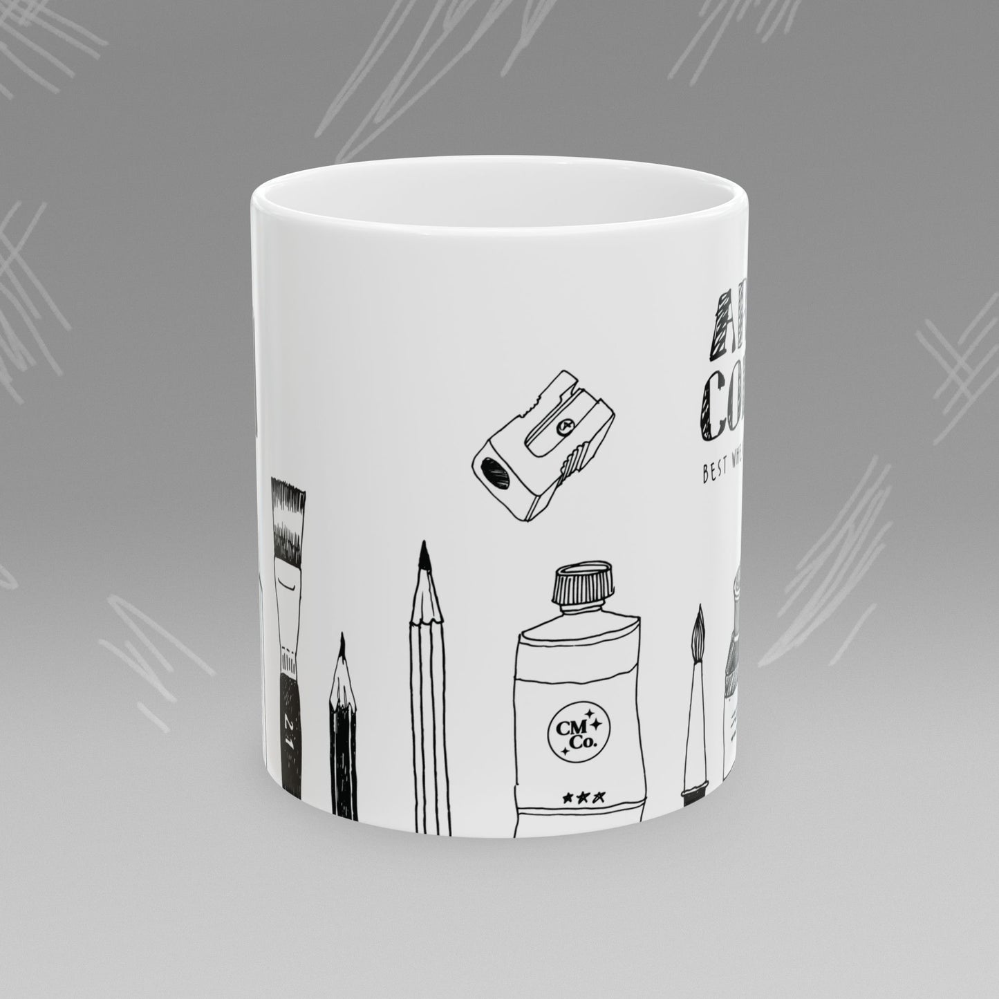 White mug with black text and illustrations of art supplies