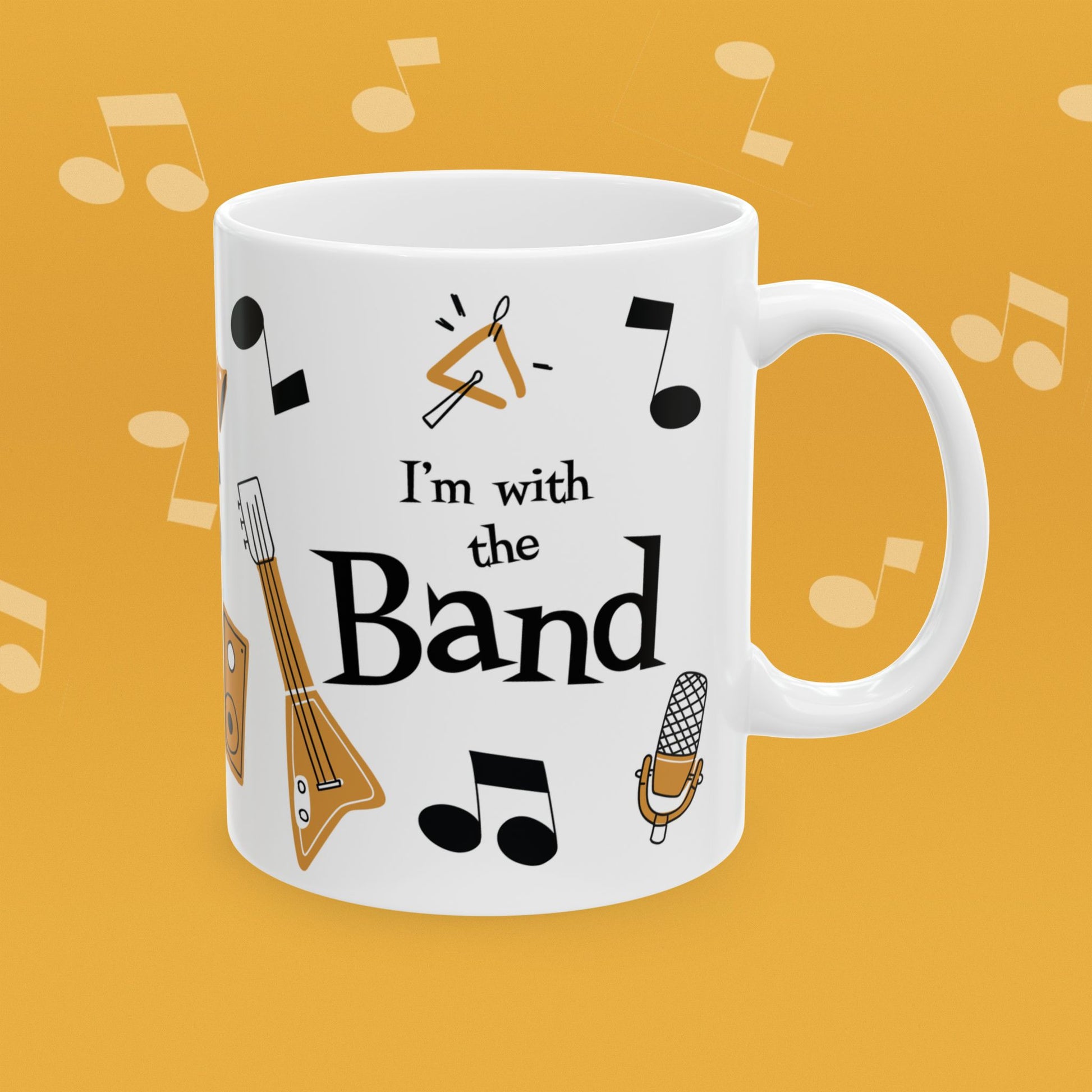 Coffee mug with musical instrument illustrations and text 'I'm with the Band' on a yellow background