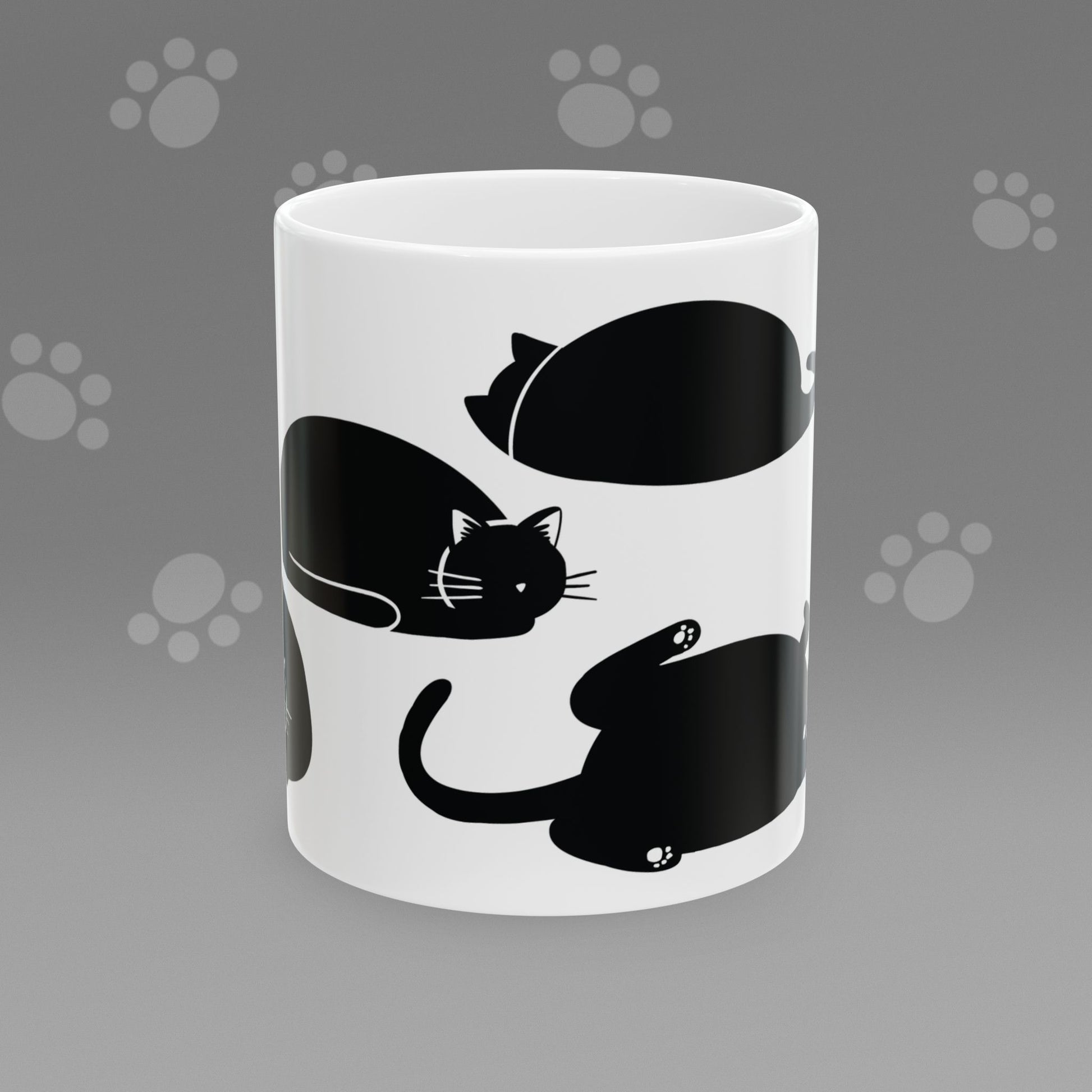 Coffee mug with fat black cat illustrations on a gray background