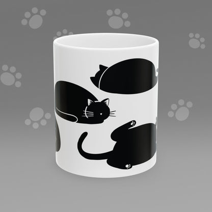 Coffee mug with fat black cat illustrations on a gray background