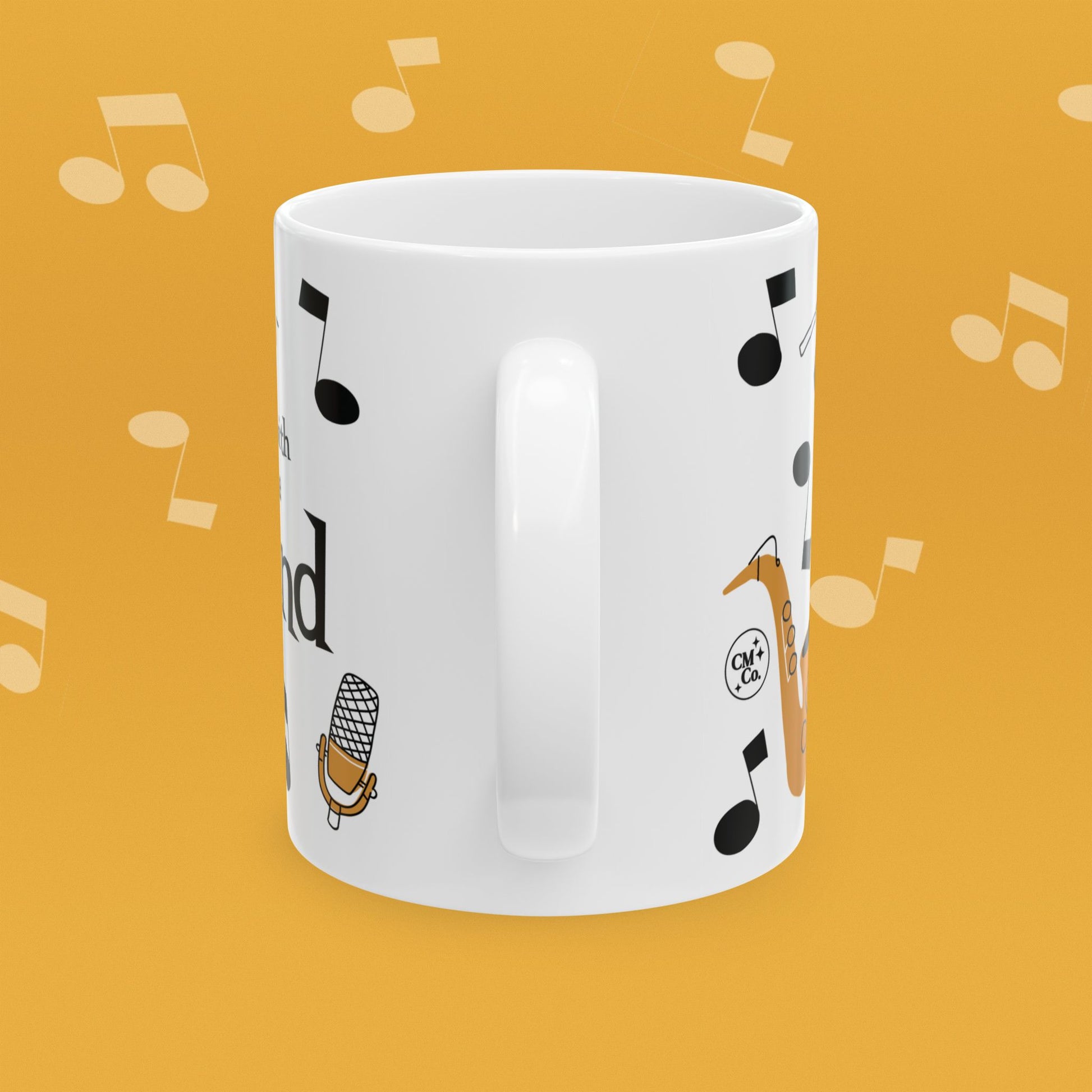Coffee mug with musical instrument illustrations and text 'I'm with the Band' on a yellow background