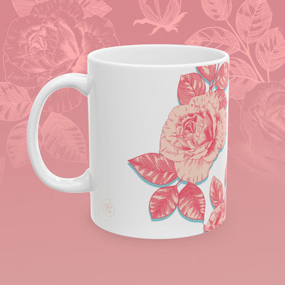 coffee mug decorated with blooming roses in shades of pink.