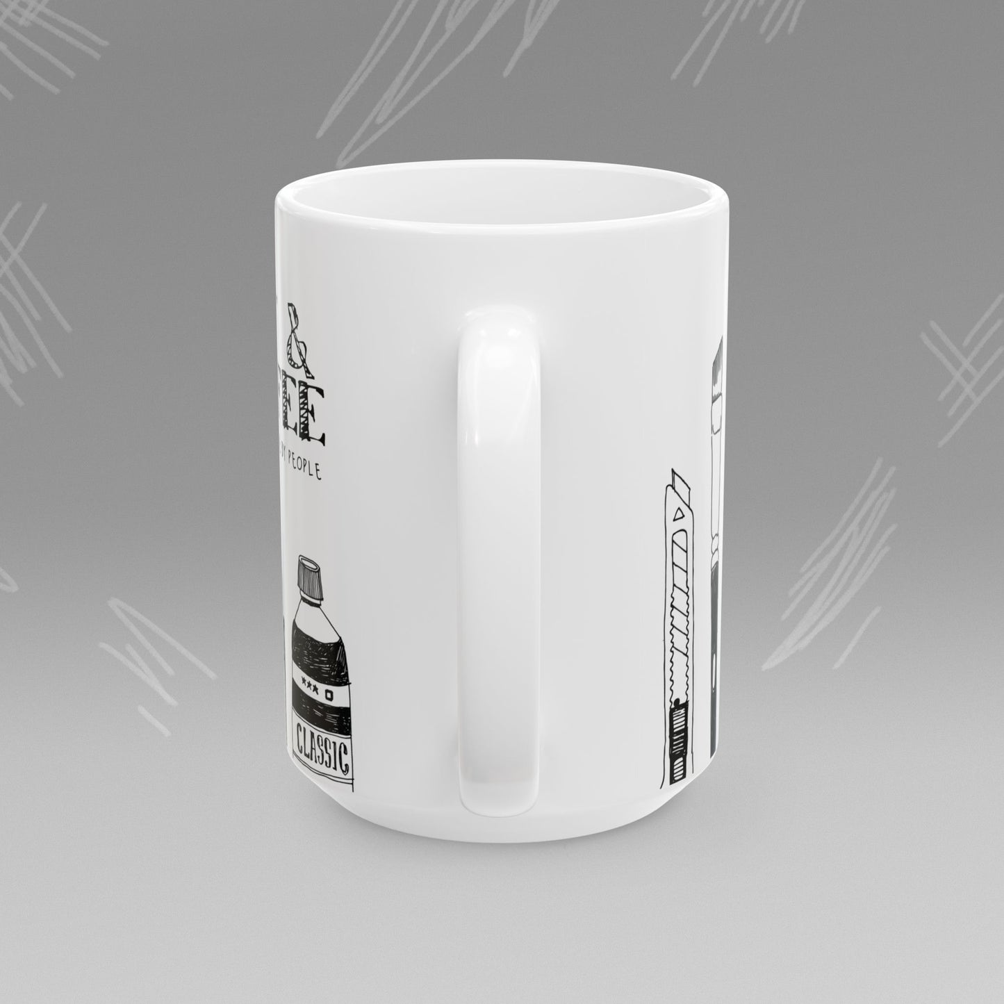 White mug with black text and illustrations of art supplies