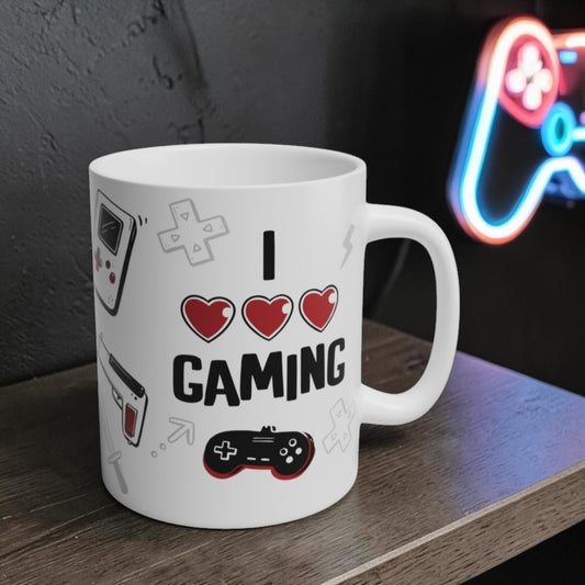 White mug with 'I ❤️ Gaming' text and gaming icons on a wooden surface.