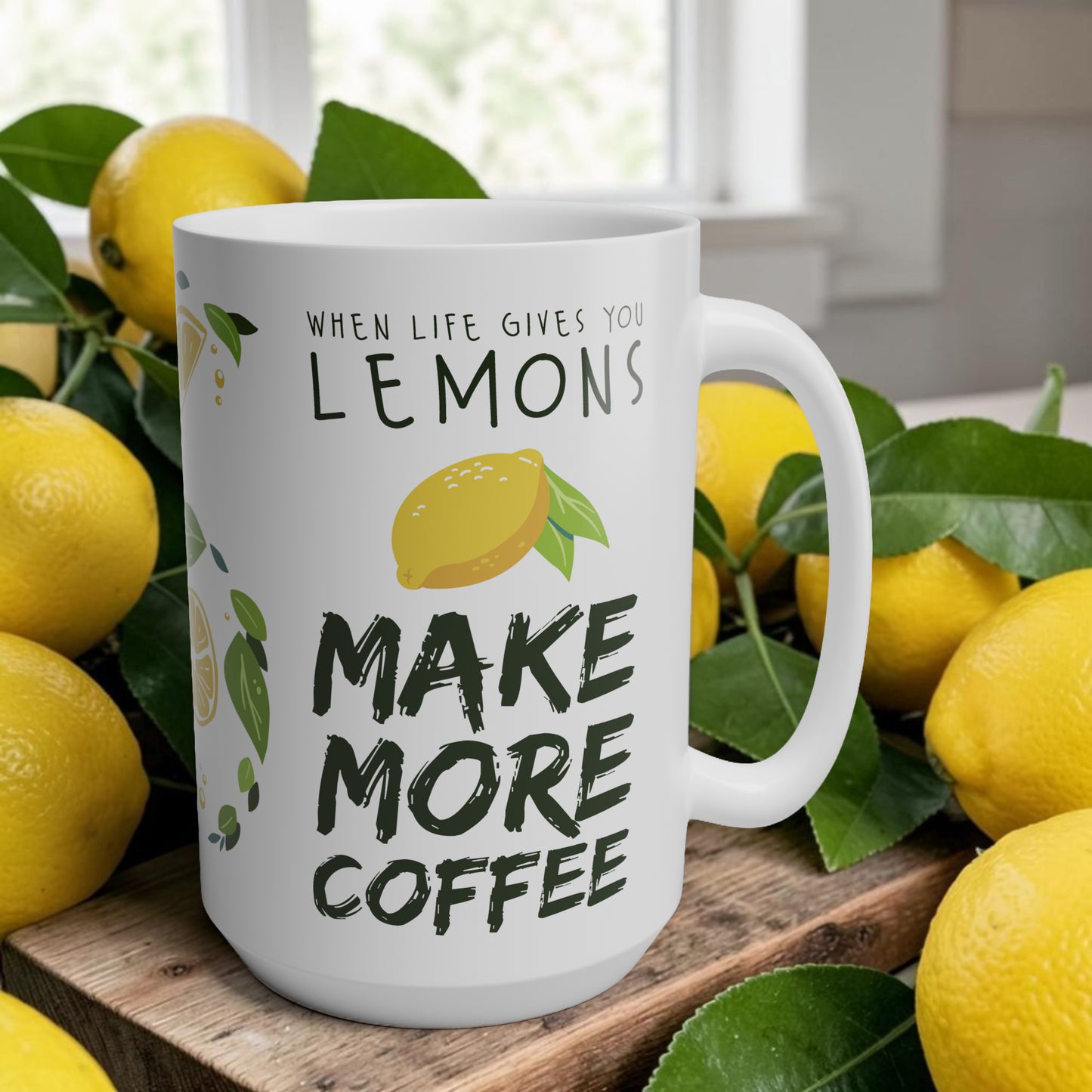 White mug with lemon design and text 'When life gives you lemons, make more coffee' surrounded by lemons on a wooden surface.