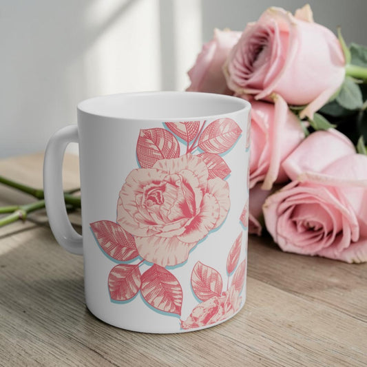 coffee mug decorated with blooming roses in shades of pink.