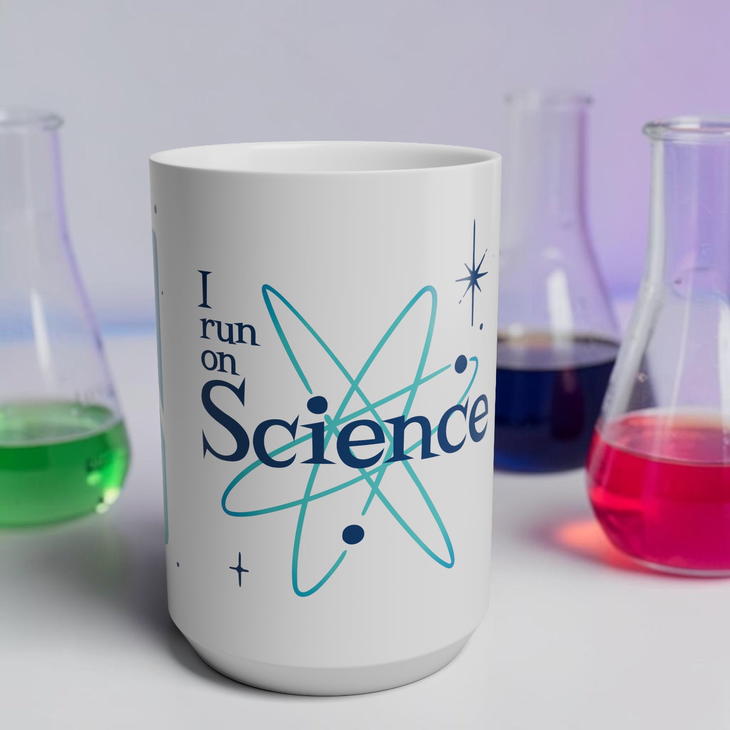 White mug with 'I run on Science' text and atom symbol, surrounded by beakers with colorful liquids.